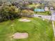 A vivid aerial shot of a golf course and community playground, with mature trees at 112 E Cumberland Cir, Longwood, FL 32779