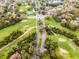 Overhead view highlighting neighborhood assets; a golf course, tennis courts, and parks at 112 E Cumberland Cir, Longwood, FL 32779