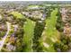 An aerial view shows a golf course with a neighborhood of single-Gathering homes nearby at 112 E Cumberland Cir, Longwood, FL 32779