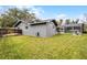 Spacious backyard featuring a well-maintained lawn and a view of the screened-in pool area, ideal for outdoor activities at 112 E Cumberland Cir, Longwood, FL 32779