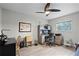 Cozy bedroom with hardwood floors, ceiling fan, and a window providing natural light at 112 E Cumberland Cir, Longwood, FL 32779