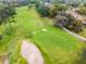 Scenic aerial view showcases a well-maintained golf course surrounded by mature trees at 112 E Cumberland Cir, Longwood, FL 32779