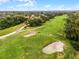 An aerial photograph highlights the lush golf course perfect for leisure and recreation at 112 E Cumberland Cir, Longwood, FL 32779