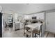 Modern kitchen with stainless steel appliances, white cabinetry, a breakfast bar, and an adjacent dining area at 112 E Cumberland Cir, Longwood, FL 32779