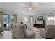 Bright living room featuring a ceiling fan, entertainment center, and sliding glass doors leading to the outdoors at 112 E Cumberland Cir, Longwood, FL 32779