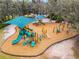 Aerial view of a playground in the community featuring fun and colorful equipment, surrounded by a leafy landscape at 112 E Cumberland Cir, Longwood, FL 32779