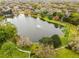 Scenic aerial view of a community pond with a fountain, surrounded by lush greenery and walking paths at 112 E Cumberland Cir, Longwood, FL 32779