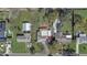 Aerial view of the property showcasing its location with a spacious yard and multiple structures at 1129 Ne 12Th St, Ocala, FL 34470