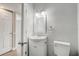 Neutral bathroom with a vanity, a medicine cabinet, and a door leading to a bedroom at 1129 Ne 12Th St, Ocala, FL 34470