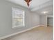 Bedroom featuring light gray walls, a dark ceiling fan, and a window with blinds at 1129 Ne 12Th St, Ocala, FL 34470