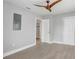 Bedroom with gray walls, a dark ceiling fan, and doorway leading to a tiled bathroom at 1129 Ne 12Th St, Ocala, FL 34470