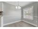 Bright dining room featuring a modern chandelier and a window offering natural light at 1129 Ne 12Th St, Ocala, FL 34470