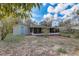 Exterior view of home with a screened-in porch and detached garage at 1129 Ne 12Th St, Ocala, FL 34470