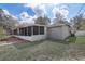 Exterior view of home with screened-in porch and well-maintained backyard at 1129 Ne 12Th St, Ocala, FL 34470