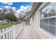 Side view of a home's exterior, showcasing a tiled walkway, white picket fence, and a charming window at 1129 Ne 12Th St, Ocala, FL 34470