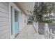 Inviting front porch with a bright blue door, white picket fence, and a tiled walkway at 1129 Ne 12Th St, Ocala, FL 34470