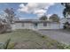 Charming single-story home featuring a bright blue door, a white picket fence, and a detached garage at 1129 Ne 12Th St, Ocala, FL 34470