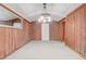 This garage features wood paneled walls, a white ceiling, and a mirrored wall at 1129 Ne 12Th St, Ocala, FL 34470