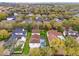 An aerial view displays the home's pool and screened-in porch within a verdant neighborhood at 11402 Camden Loop Way, Windermere, FL 34786