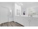 Bright bathroom with dual sinks, white cabinets, and neutral walls at 11402 Camden Loop Way, Windermere, FL 34786