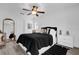 Bright bedroom featuring a ceiling fan, neutral walls, and sleek wood-look flooring at 11402 Camden Loop Way, Windermere, FL 34786