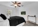 Bright bedroom featuring a large window and neutral walls, complete with sleek wood-look flooring at 11402 Camden Loop Way, Windermere, FL 34786