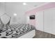 Bright bedroom featuring light pink accent wall, a hammock chair, and wood-look floors at 11402 Camden Loop Way, Windermere, FL 34786