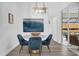 Bright dining area with slider to an outdoor kitchen and blue velvet chairs at 11402 Camden Loop Way, Windermere, FL 34786