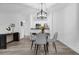 Cozy dining area features a glass table with gray chairs and modern pendant lighting at 11402 Camden Loop Way, Windermere, FL 34786