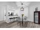 Cozy dining area features a glass table with chairs and modern pendant lighting at 11402 Camden Loop Way, Windermere, FL 34786