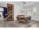 Dining area with modern light fixture, wood look floors and seating for six at 11402 Camden Loop Way, Windermere, FL 34786