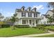 Beautiful two-story home featuring a manicured lawn, a white picket fence, and mature landscaping at 11402 Camden Loop Way, Windermere, FL 34786