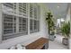 Cozy front porch featuring a wooden bench, rocking chairs, and decorative potted plants at 11402 Camden Loop Way, Windermere, FL 34786