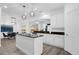 Elegant kitchen featuring an island, granite countertops, white cabinets, and pendant lights at 11402 Camden Loop Way, Windermere, FL 34786