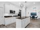 Modern kitchen featuring an island, granite countertops, white cabinets and stainless appliances at 11402 Camden Loop Way, Windermere, FL 34786