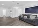 Comfortable gray couch in a well-lit living room with wood-look tile flooring at 11402 Camden Loop Way, Windermere, FL 34786