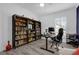 Bright home office featuring built-in shelving, wood-look floors, and a large window at 11402 Camden Loop Way, Windermere, FL 34786