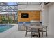 A fully equipped outdoor kitchen adjacent to the pool, perfect for entertaining guests at 11402 Camden Loop Way, Windermere, FL 34786