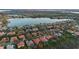 A beautiful lake neighborhood featuring tile roofs, mature landscaping, and scenic lake views from an aerial perspective at 11733 Delwick Dr, Windermere, FL 34786