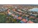 View of a neighborhood near a lake showcasing mature trees and tiled roofs at 11733 Delwick Dr, Windermere, FL 34786