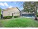 View of the home's backyard showcasing the screened-in pool, lush lawn, and attractive landscaping at 11733 Delwick Dr, Windermere, FL 34786