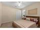 Comfortable bedroom featuring a queen-sized bed, ceiling fan, and natural light from the window at 11733 Delwick Dr, Windermere, FL 34786