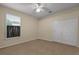 Well-lit bedroom with a ceiling fan, window, and closet at 11733 Delwick Dr, Windermere, FL 34786