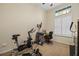 Bright bedroom featuring a home office setup and exercise equipment at 11733 Delwick Dr, Windermere, FL 34786