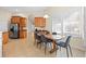 Warm and inviting dining area featuring wood table, stylish chairs, and ample natural light from shuttered windows at 11733 Delwick Dr, Windermere, FL 34786