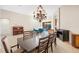 Open-concept dining room with a chandelier and seating for eight at 11733 Delwick Dr, Windermere, FL 34786