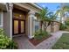 Inviting front entrance with a brick paved walkway, well manicured landscaping, and a double door entry into the home at 11733 Delwick Dr, Windermere, FL 34786