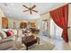 Spacious living room with a ceiling fan, opening to the kitchen and featuring a patio door at 11733 Delwick Dr, Windermere, FL 34786