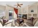 Comfortable living room featuring a fireplace, plush seating, and natural light from sliding glass doors at 11733 Delwick Dr, Windermere, FL 34786