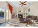 Bright living room with fireplace, a ceiling fan and access to the pool at 11733 Delwick Dr, Windermere, FL 34786